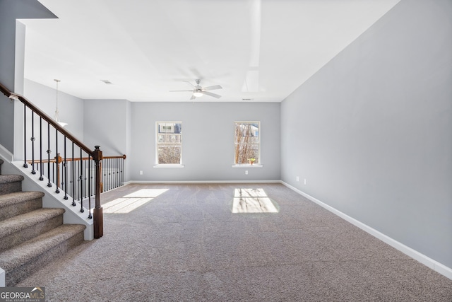 unfurnished living room with ceiling fan and carpet flooring