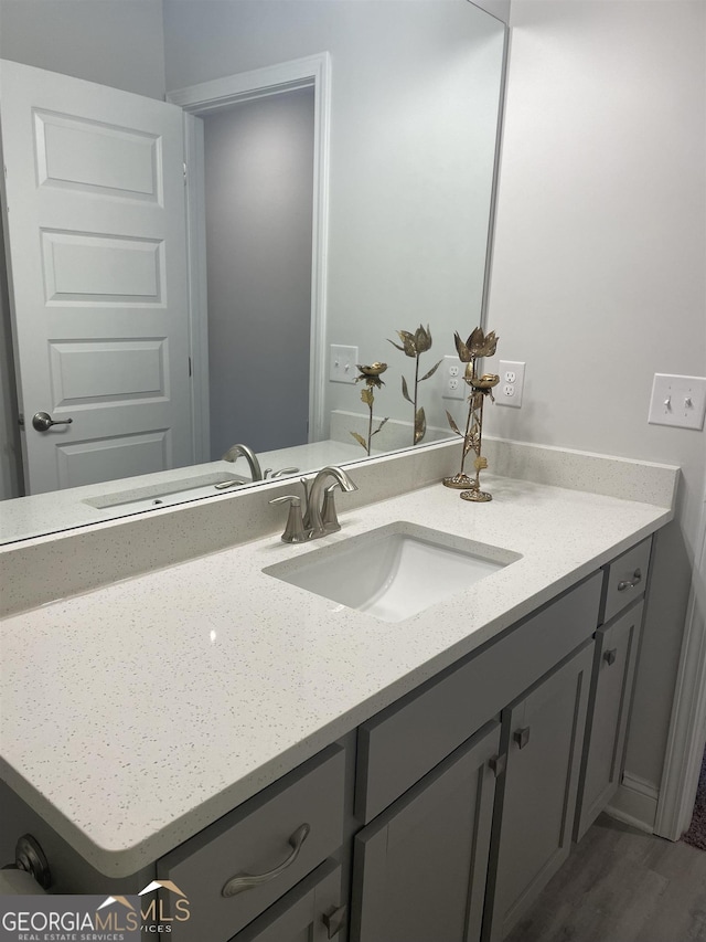 bathroom featuring wood-type flooring and vanity