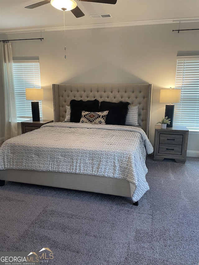 carpeted bedroom with ornamental molding and ceiling fan