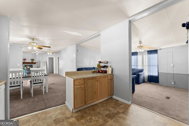 kitchen with light colored carpet and ceiling fan