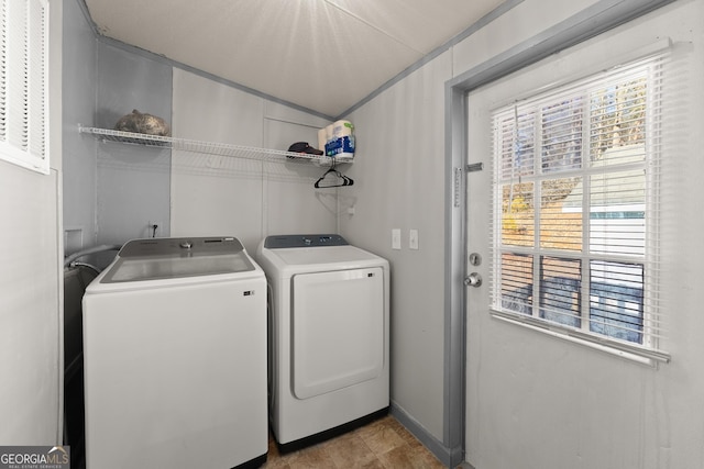 laundry room featuring washer and dryer and a wealth of natural light