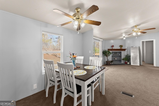 dining room with ceiling fan and carpet floors