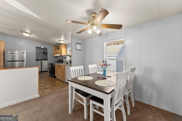 carpeted dining area with ceiling fan, lofted ceiling, and washer and clothes dryer