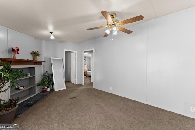 unfurnished living room featuring ceiling fan, built in features, and dark carpet