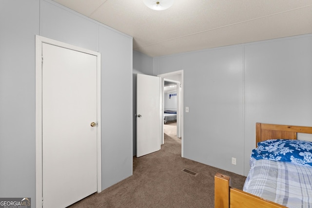 carpeted bedroom with a closet