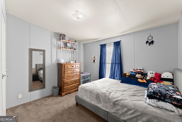 bedroom featuring a textured ceiling and carpet