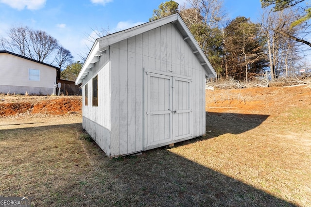 view of outdoor structure with a lawn