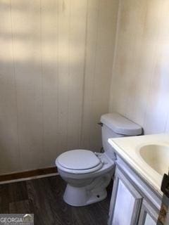 bathroom featuring vanity, toilet, and hardwood / wood-style floors