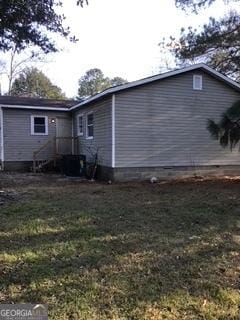 view of side of home featuring a lawn