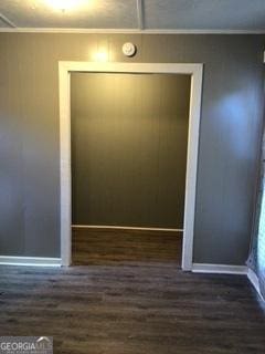 interior space featuring dark hardwood / wood-style flooring and ornamental molding