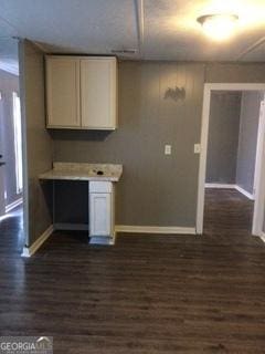 kitchen with dark wood-type flooring and white cabinets