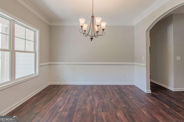 spare room featuring ornamental molding, a chandelier, and dark hardwood / wood-style flooring