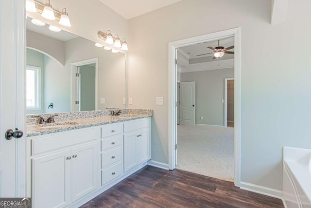 bathroom featuring vanity, wood-type flooring, and ceiling fan