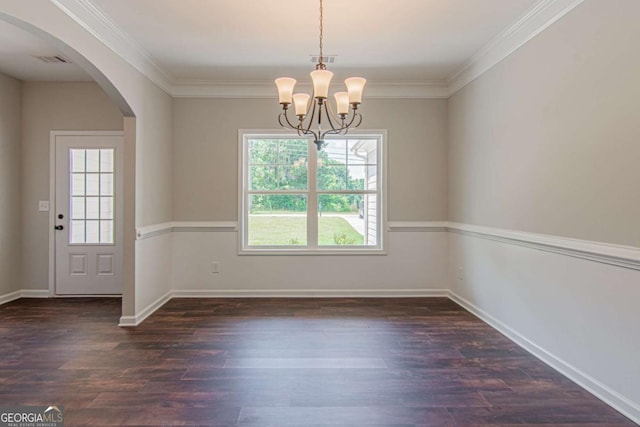 unfurnished dining area featuring ornamental molding, dark hardwood / wood-style floors, and a chandelier