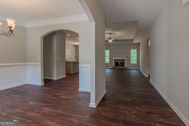 interior space with dark hardwood / wood-style flooring, a notable chandelier, and crown molding