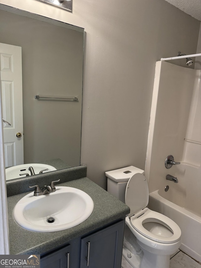 full bathroom featuring toilet, vanity, bathtub / shower combination, and a textured ceiling