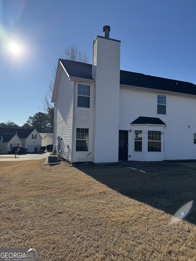 rear view of property featuring a yard