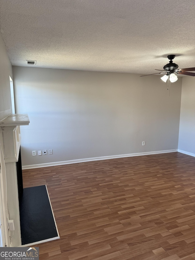 spare room featuring ceiling fan, a textured ceiling, and dark hardwood / wood-style flooring