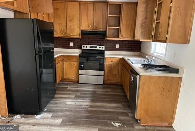 kitchen with appliances with stainless steel finishes, tasteful backsplash, sink, dark hardwood / wood-style flooring, and exhaust hood