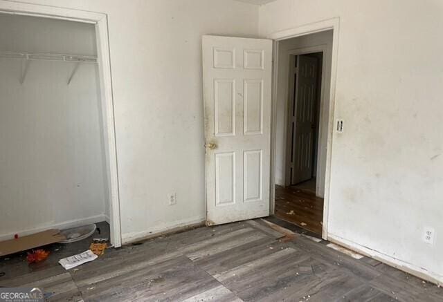 unfurnished bedroom featuring dark wood-type flooring