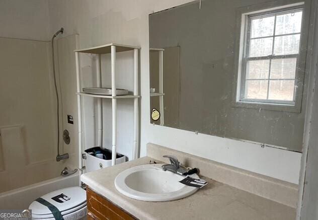 full bathroom featuring shower / bathtub combination, vanity, and toilet