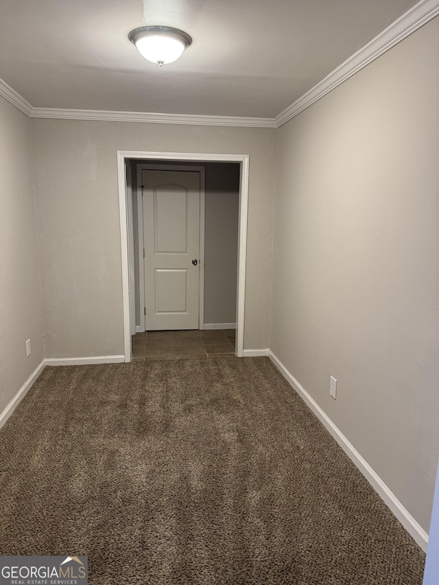 unfurnished bedroom with crown molding, carpet floors, and a closet