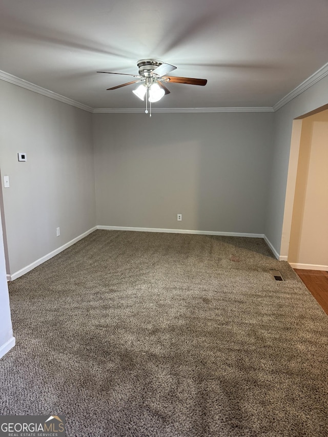 carpeted spare room featuring crown molding and ceiling fan