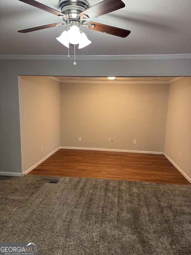 empty room with crown molding, dark hardwood / wood-style floors, and ceiling fan