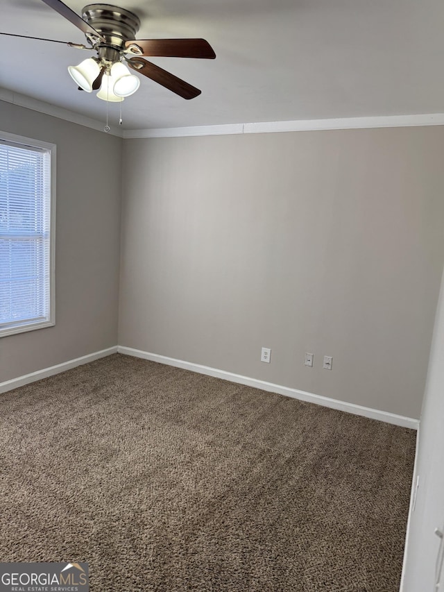 carpeted spare room with ornamental molding and ceiling fan