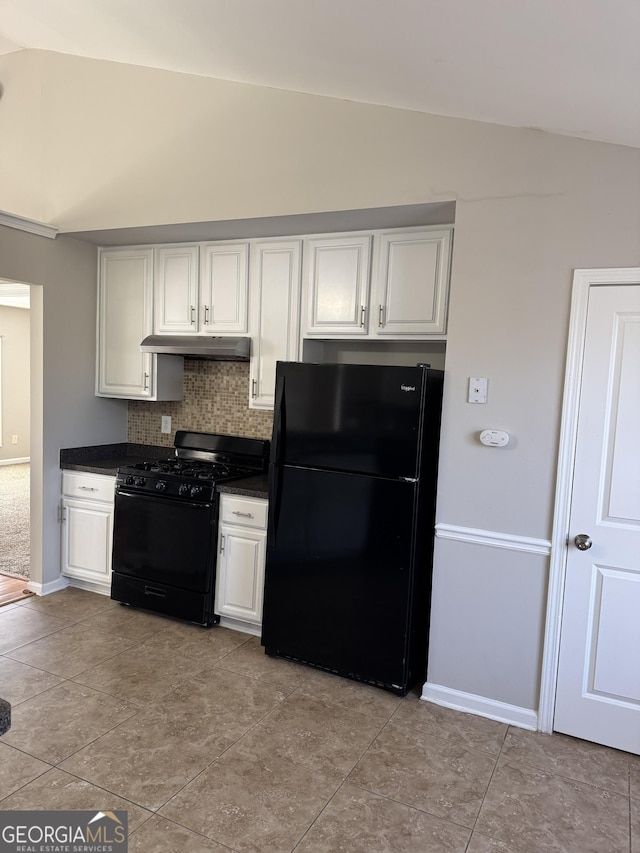 kitchen featuring tasteful backsplash, white cabinets, vaulted ceiling, and black appliances