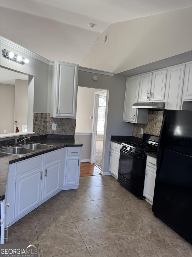 kitchen featuring sink, white cabinets, backsplash, and black appliances