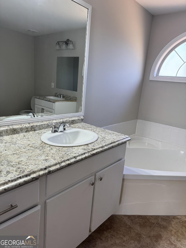 bathroom with vanity and a washtub