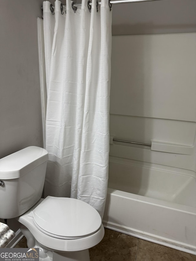 bathroom featuring shower / tub combo with curtain and toilet