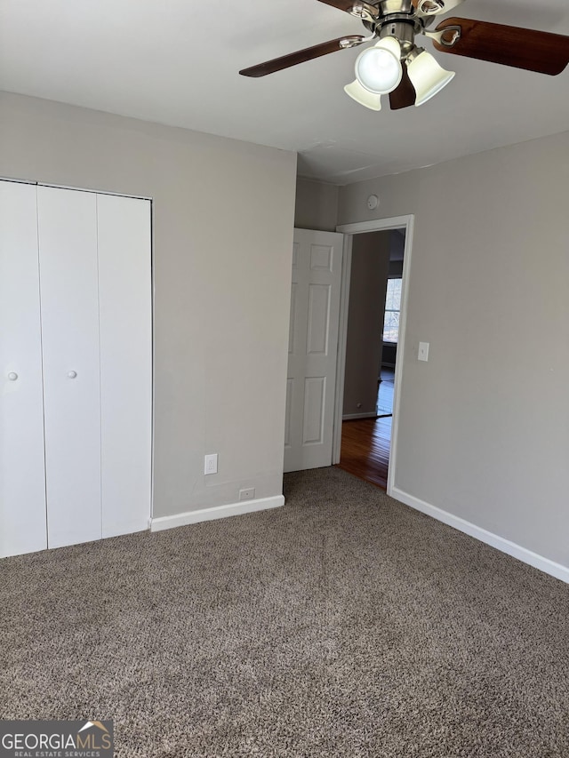 unfurnished bedroom featuring carpet flooring, ceiling fan, and a closet