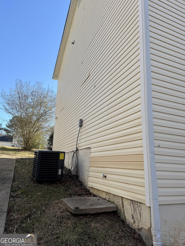 view of side of property featuring central air condition unit