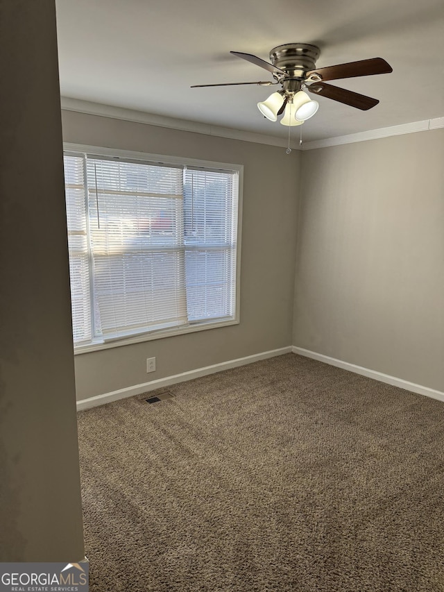 carpeted empty room featuring crown molding and ceiling fan