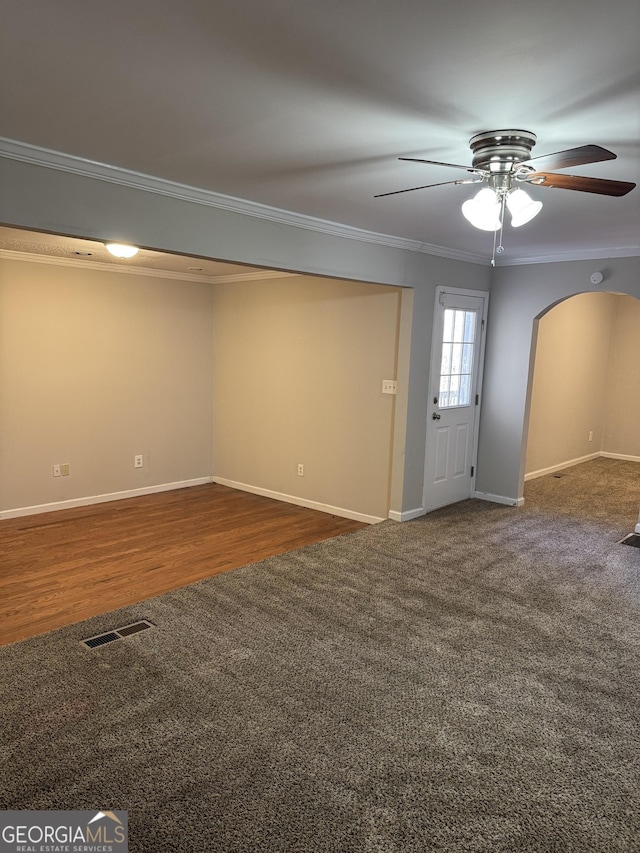 carpeted empty room featuring crown molding and ceiling fan