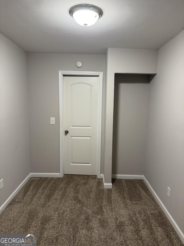 empty room with dark carpet