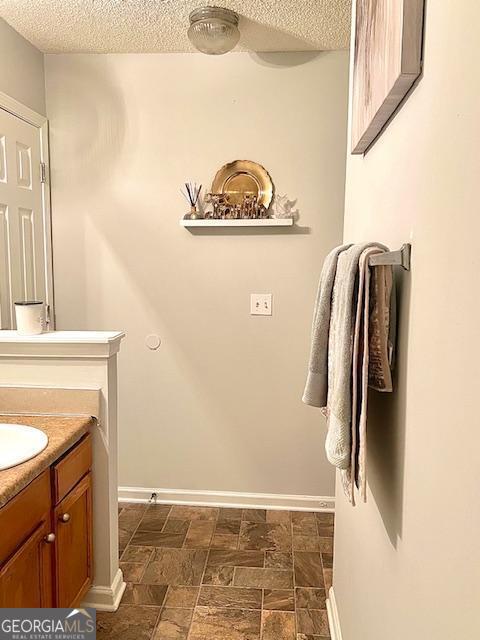 bathroom featuring vanity and a textured ceiling