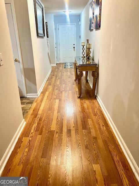 corridor with light wood-type flooring