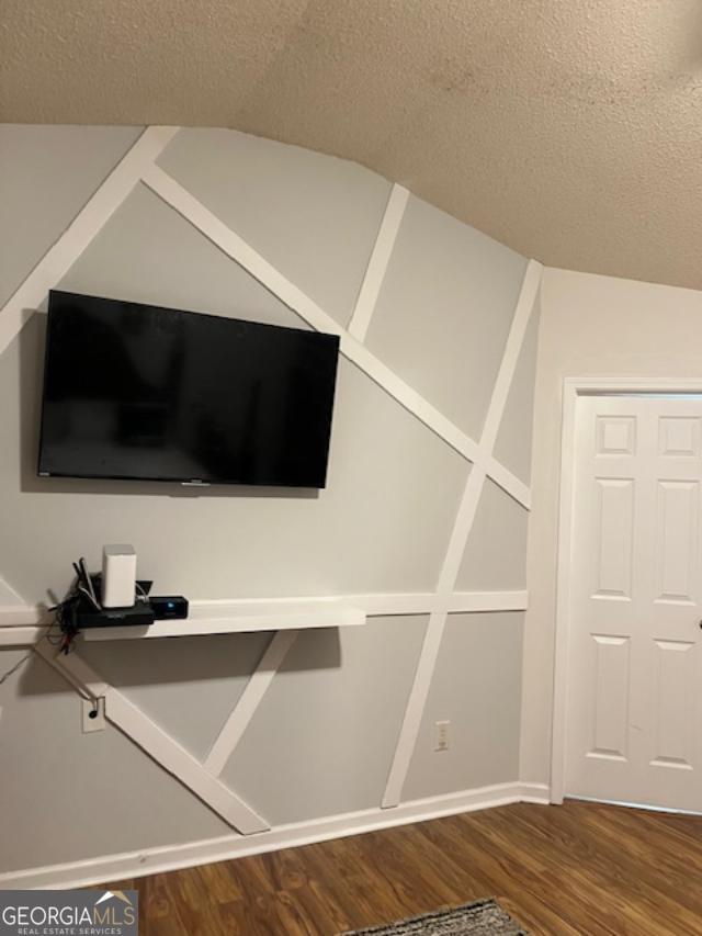 interior details featuring hardwood / wood-style floors and a textured ceiling