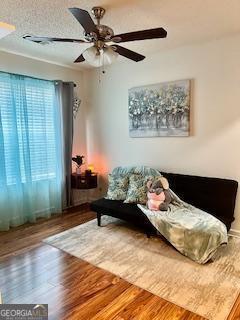 interior space featuring hardwood / wood-style flooring and ceiling fan