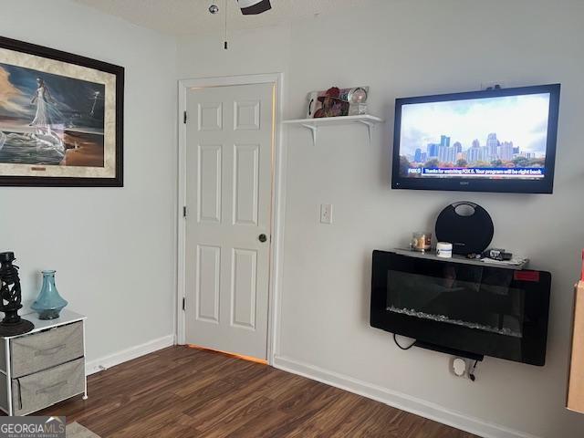 interior space with dark hardwood / wood-style flooring and ceiling fan