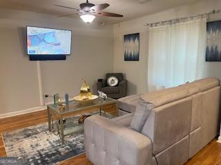 living room featuring hardwood / wood-style flooring and ceiling fan