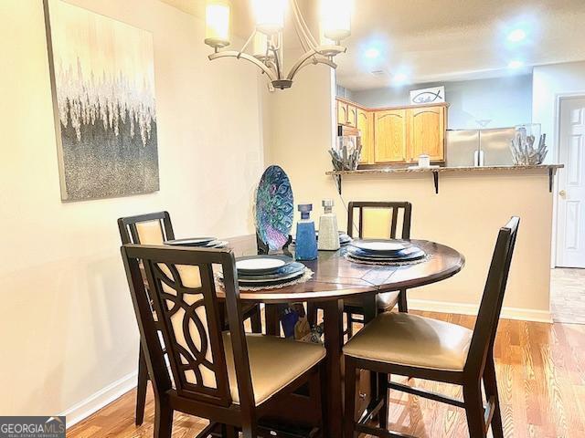 dining area featuring a notable chandelier and light hardwood / wood-style floors