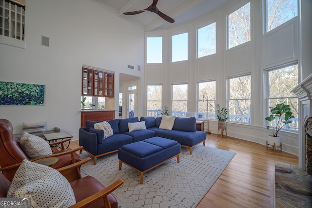 living room featuring ceiling fan and light wood-type flooring