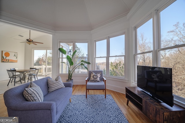 sunroom / solarium featuring ceiling fan