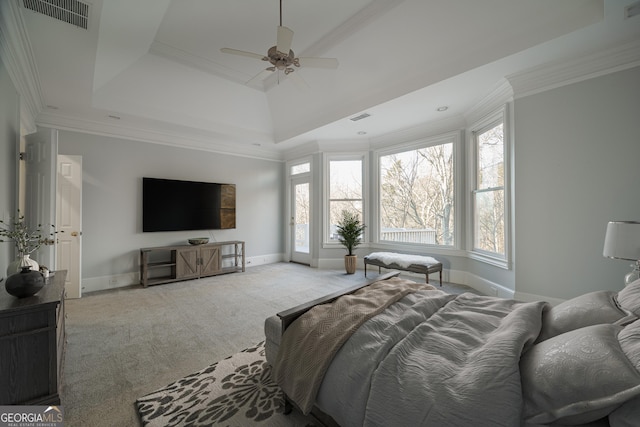 carpeted bedroom featuring ceiling fan, ornamental molding, and a raised ceiling