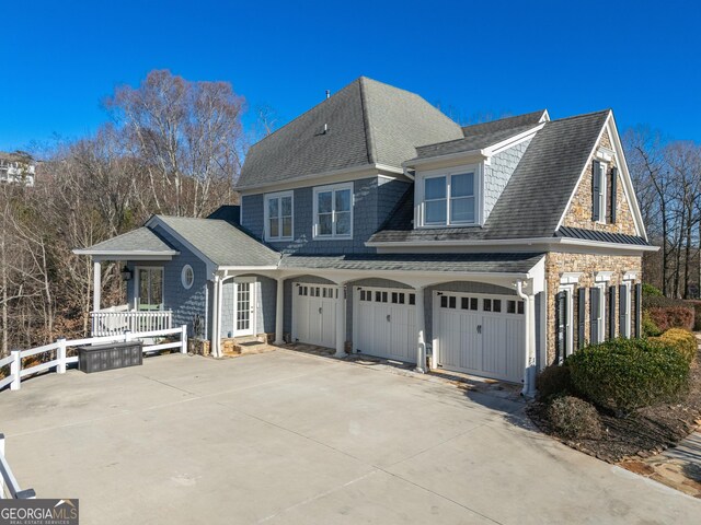 view of side of home with a garage and a porch