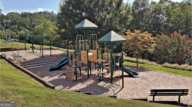 view of playground with a lawn